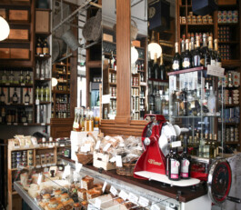 Comptoir charcuterie épicerie fine Le Comptoir de la Gastronomie Paris Ier — machine à trancher vintage boiseries — rénovation Bilal Deshayes architecte d'intérieur Paris